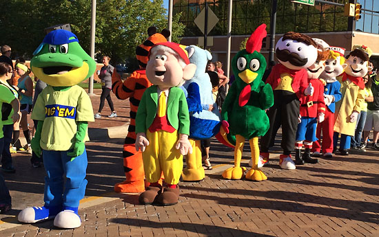 Mascots waiting to greet runners after the finish line.